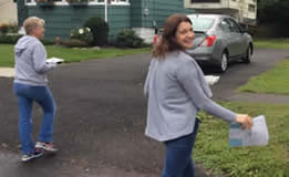 A volunteer delivering a packaged meal