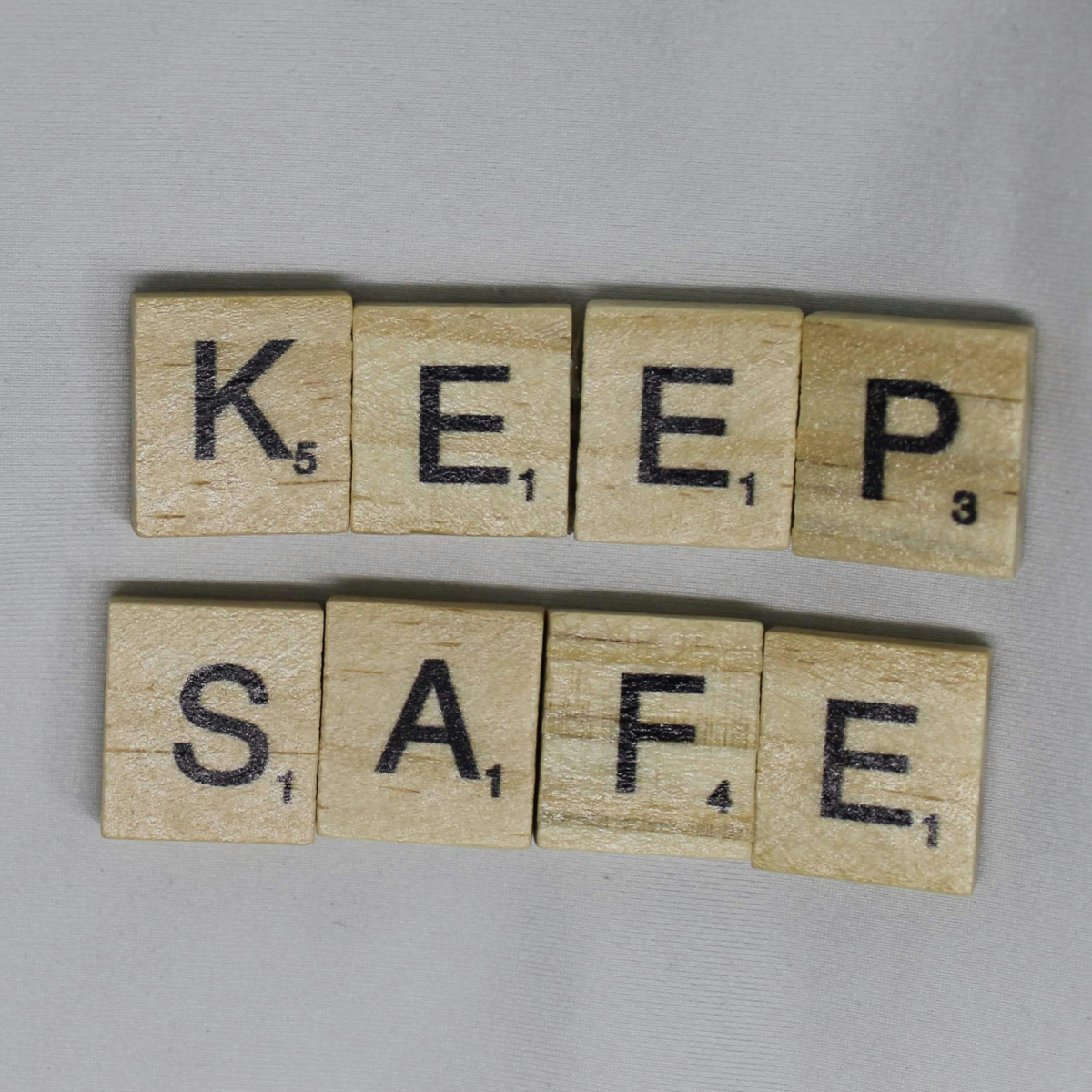 Scrabble tiles spelling out "Keep Safe"