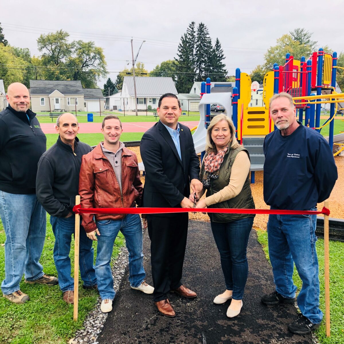 Ryan McMahon cutting a ribbon at a new park.