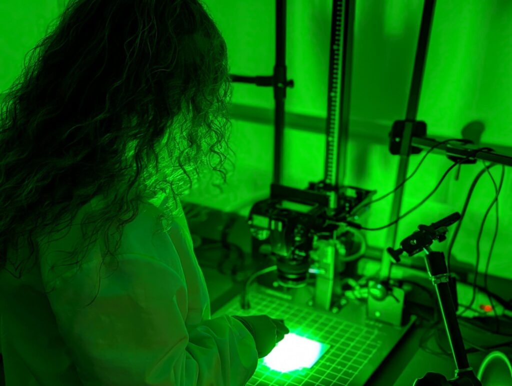 Latent Print Examiner uses a laser for latent print processing examination