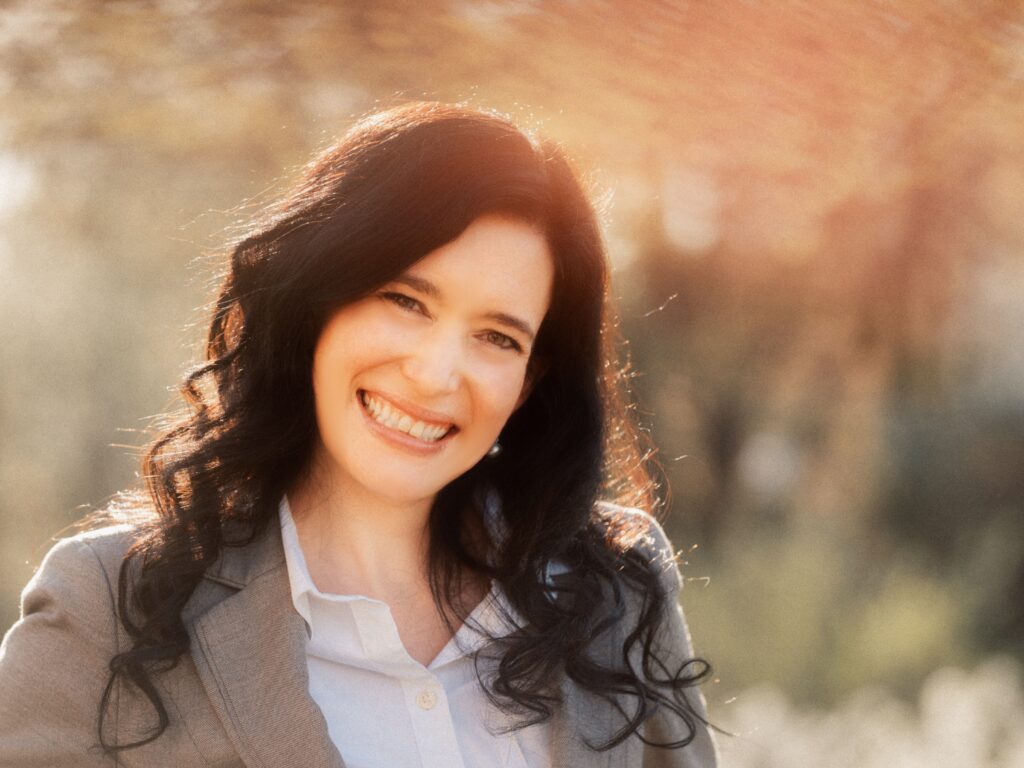 woman, headshot, white shirt brown jacket