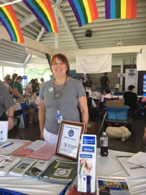 A NY Connects employee works a table at the NYS Fair on Pride Day.